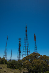 Multiple communications towers on a hilltop - vertical