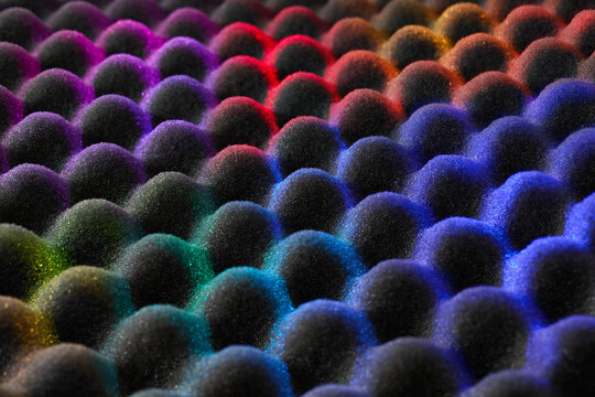 Colorful lights on acoustic foam texture
