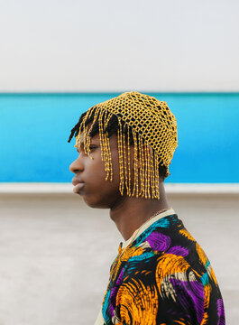Side profile of young man in golden bead headpiece
