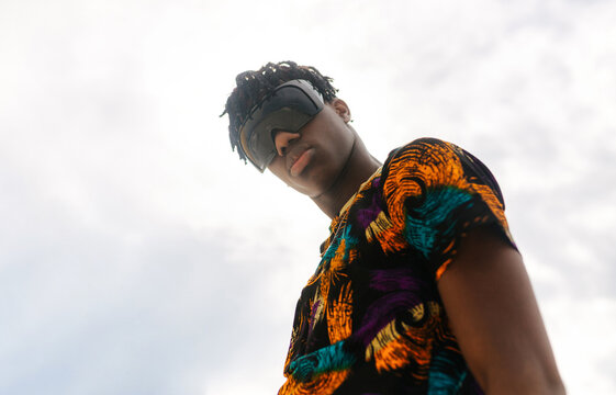 Man wearing traditional African shirt against sky portrait