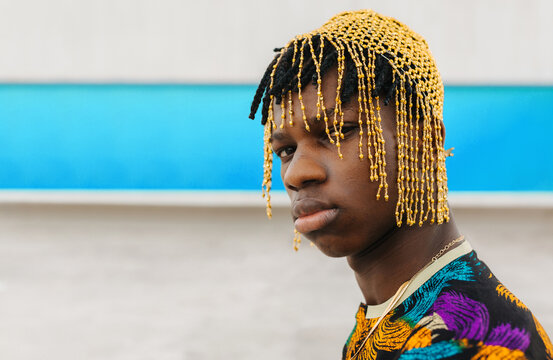 Close-up portrait of man wearing golden bead veil