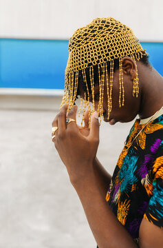 Man adjusting beaded headpiece portrait
