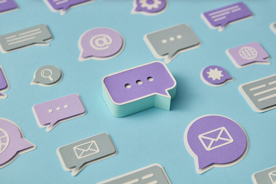 Papercraft chat bubbles on blue surface - Powered by Adobe