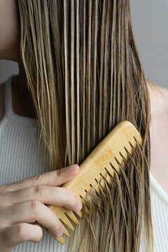 Combing Wet Blonde Hair with Wooden Comb