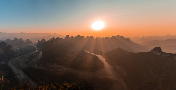 Silhouettes of karst mountains and Li River in Yangshuo, China 