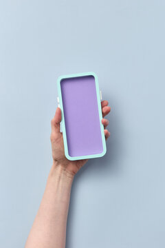 Hand holding papercraft phone with purple screen