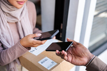 Contactless delivery: Woman scans to confirm receipt