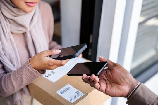 Contactless delivery: Woman scans to confirm receipt