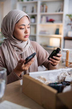 Woman comparing online description with real product
