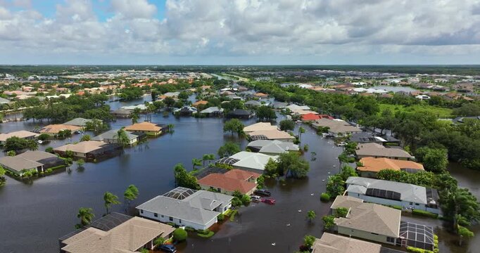 Flooded houses and cars from hurricane rainfall water in Florida residential community. Aftermath of natural disaster in USA south