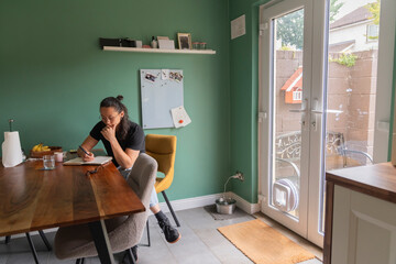 Man Takes Notes in Cozy Dining Room Filled With Natural Light
