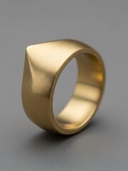 Unique Golden Ring Close-up on Grey Background with Geometric Top Design