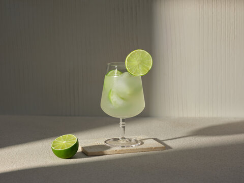 A refreshing lime cocktail, garnished with a lime slice