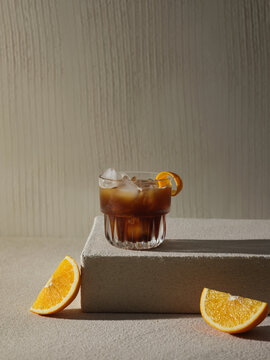A glass of iced cold brew cocktail with orange zest