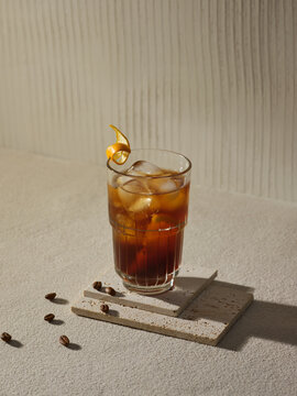 A refreshing iced coffee with a twist of orange