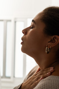 Woman crying in bathroom with eyes closed 