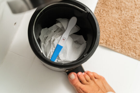 Woman disposing used pregnancy test