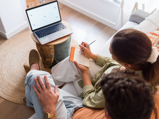 Couple taking notes during consultation 