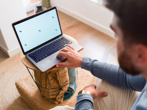 Man Using Laptop in Cozy Room
