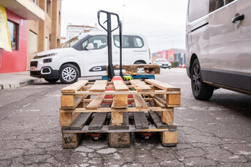 Wooden pallets stacked on a pallet truck for loading, unloading, and transporting goods from a...