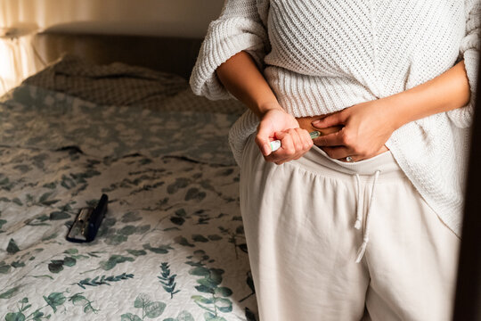Woman injecting GLP-1 at home 