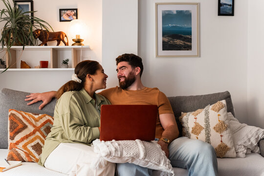 Couple Enjoys Quality Time Together at Home With Laptop