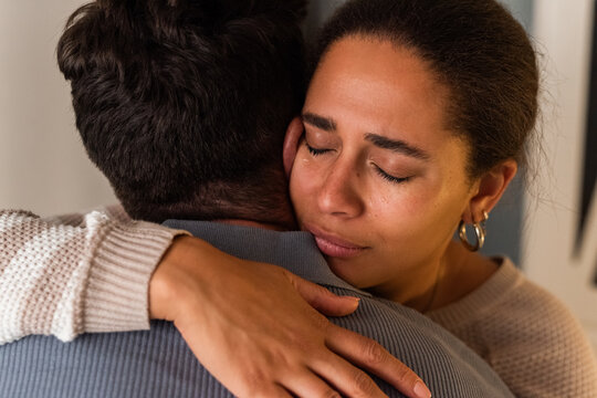 Man supporting crying wife 