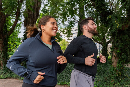 Couple with higher BMI jogging at park 