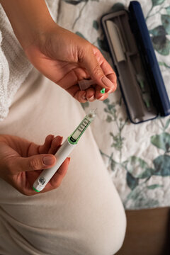 Person Preparing Insulin Pen for Diabetes Management at Home