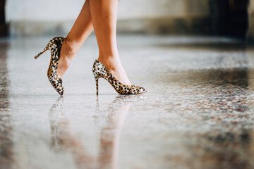 Leopard print high heel shoes on terrazzo floor with elegant legs, stylish fashion, modern interior, and classic veneziano design, creating chic and confident atmosphere
