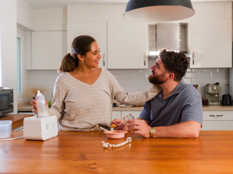 Couple preparing baby food 