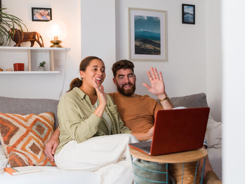 Couple waving hands during video call