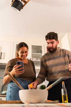 Couple Cooking Together in a Bright Kitchen While Having Fun