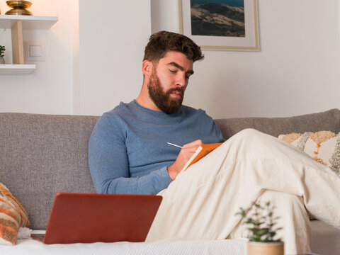 Focused man writing notes