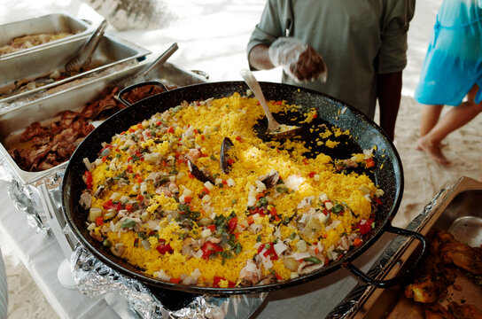 Vibrant Seafood Paella Prepared at a Beachside Gathering
