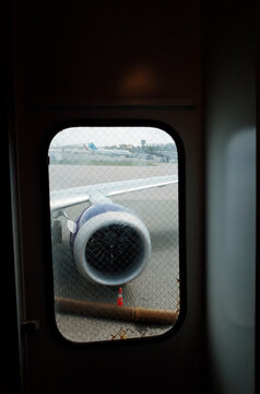 Airport View of Aircraft Engine and Runway Before Departure
