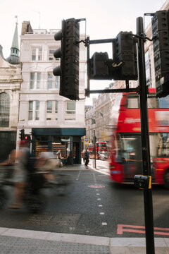 Traffic light and red bus in motion
