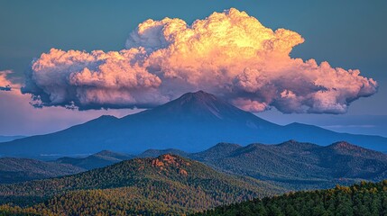 Mountain range at sunset, large cloud over peak