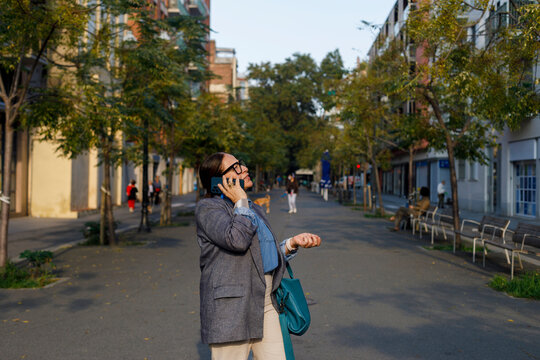 Woman Talks on Phone on Street