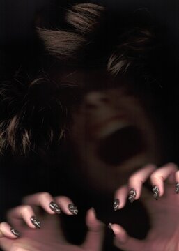 A creepy person in the dark screams