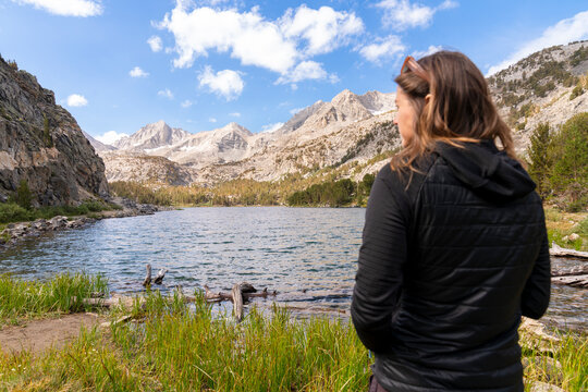 hiker looking at view of lake 