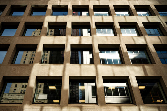 Window city reflections in concrete wall grid