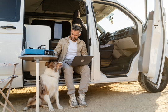 Man working outdoors with dog