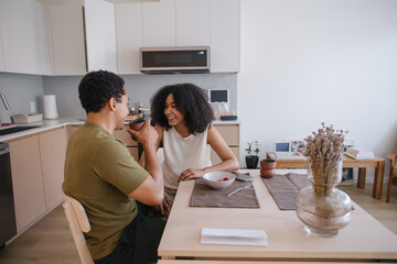 Candid moment of couple sharing coffee in a modern kitchen