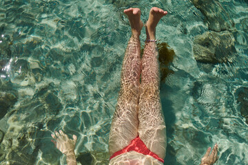 Floating Legs in Crystal Clear Water