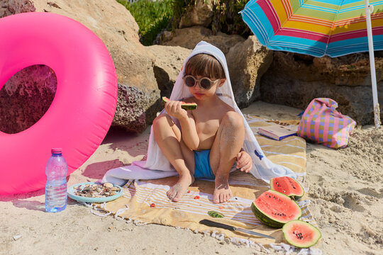 Cute Toddler Eating Watermelon on a Sunny Beach