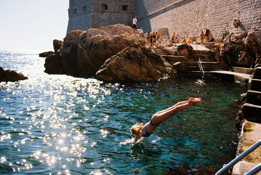 Woman dives into the water