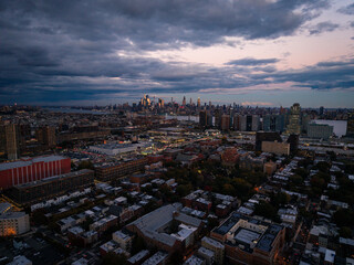 Manhattan skyline and Jersey City rooftops at twilight
