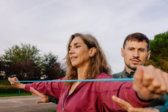 Trainer working on the physical strength of an empowered elderly woman