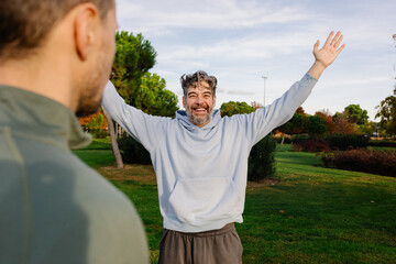 Elderly man practices calm meditation during an outdoor yoga session